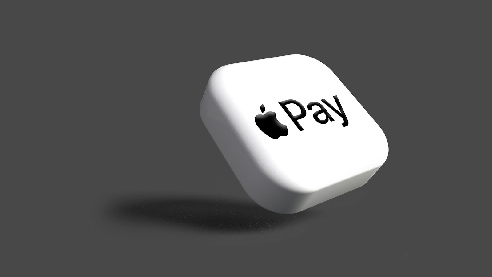 A white die showing the word Pay